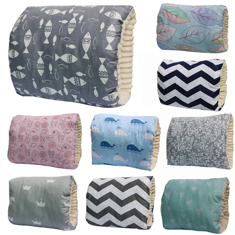 Nine soft cotton nursing pillows in various patterns: fish, leaves, chevron, and more, with plush trim.