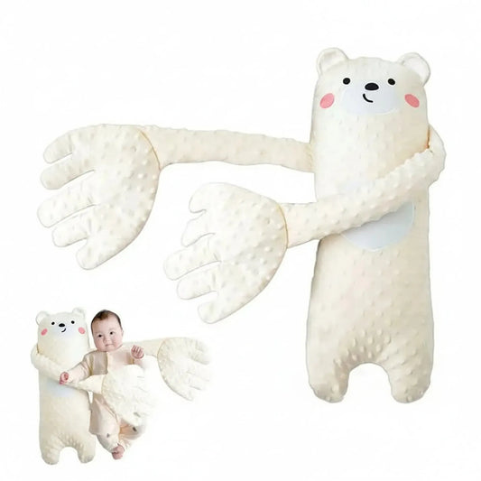 White plush bear baby soothing pillow with long arms, textured fabric, and a baby sleeping soundly.