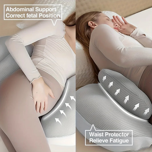 Pregnant woman sleeping with a gray U-shaped maternity pillow for abdominal and waist support.