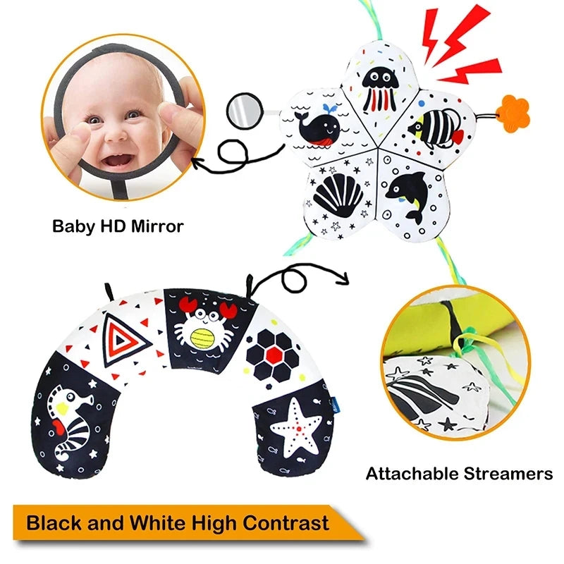 Black and white high-contrast tummy time pillow with mirror and attachable sea creature toys.