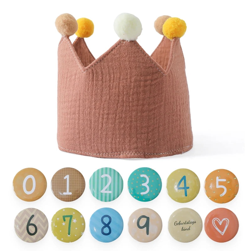 Pink cotton baby birthday crown with colorful pom-poms and interchangeable number pins 0-9.