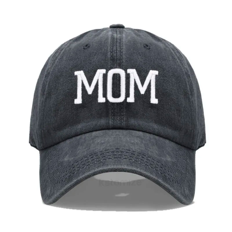 Adjustable black cotton baseball cap with "MOM" embroidered in white.