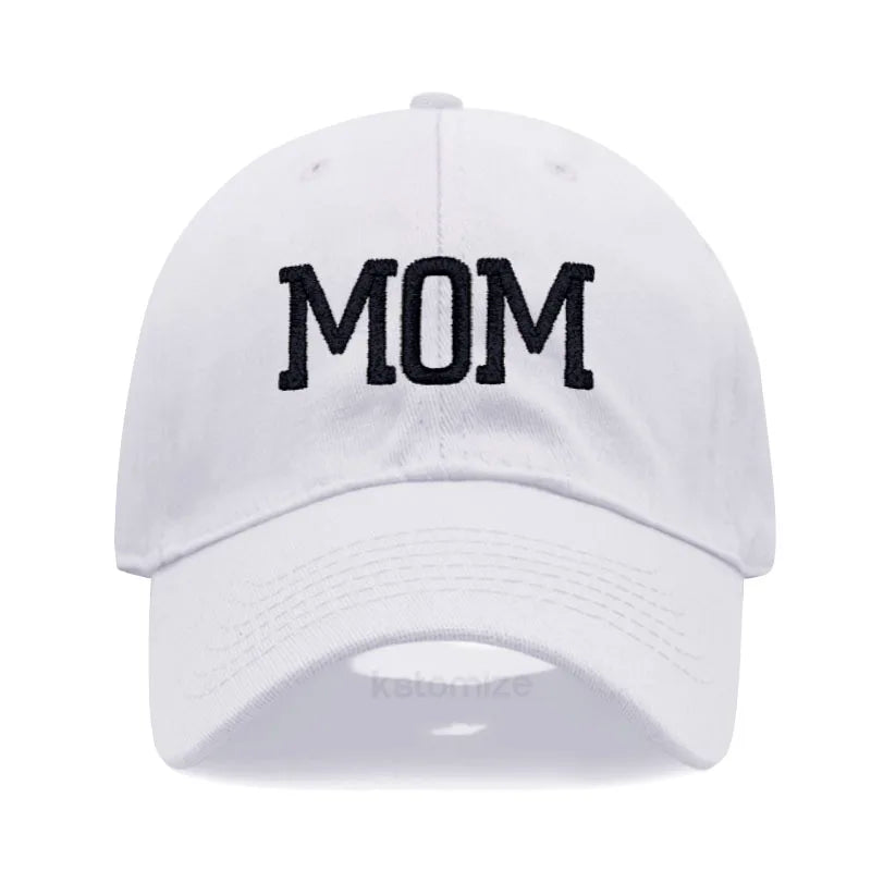 White cotton baseball cap with "MOM" embroidered in black, adjustable for adults.