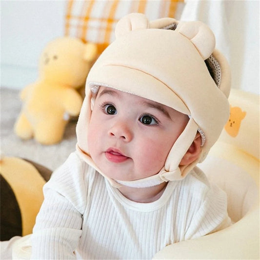 Cute baby wearing a beige, breathable anti-collision helmet with bear ears, perfect for toddlers learning to walk.