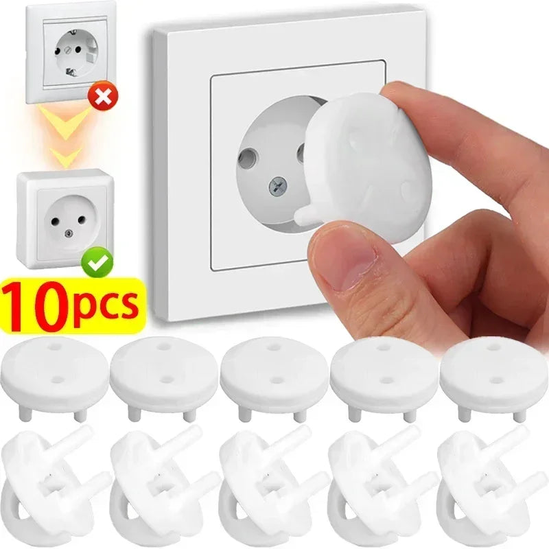 White ABS plastic child safety outlet covers for French standard sockets, shown with a hand inserting one.