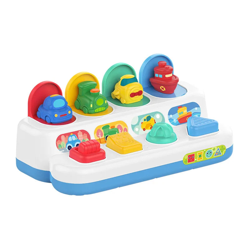 Colorful pop-up interactive toy for toddlers, featuring cars and a boat, with push, twist, and slide buttons.