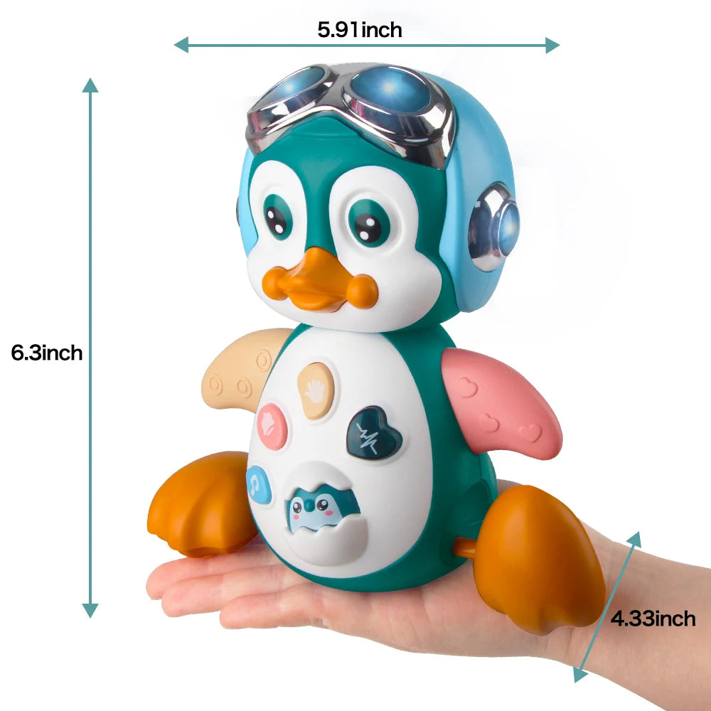 Interactive crawling musical penguin toy with lights, wearing goggles, held in a hand, showing dimensions.