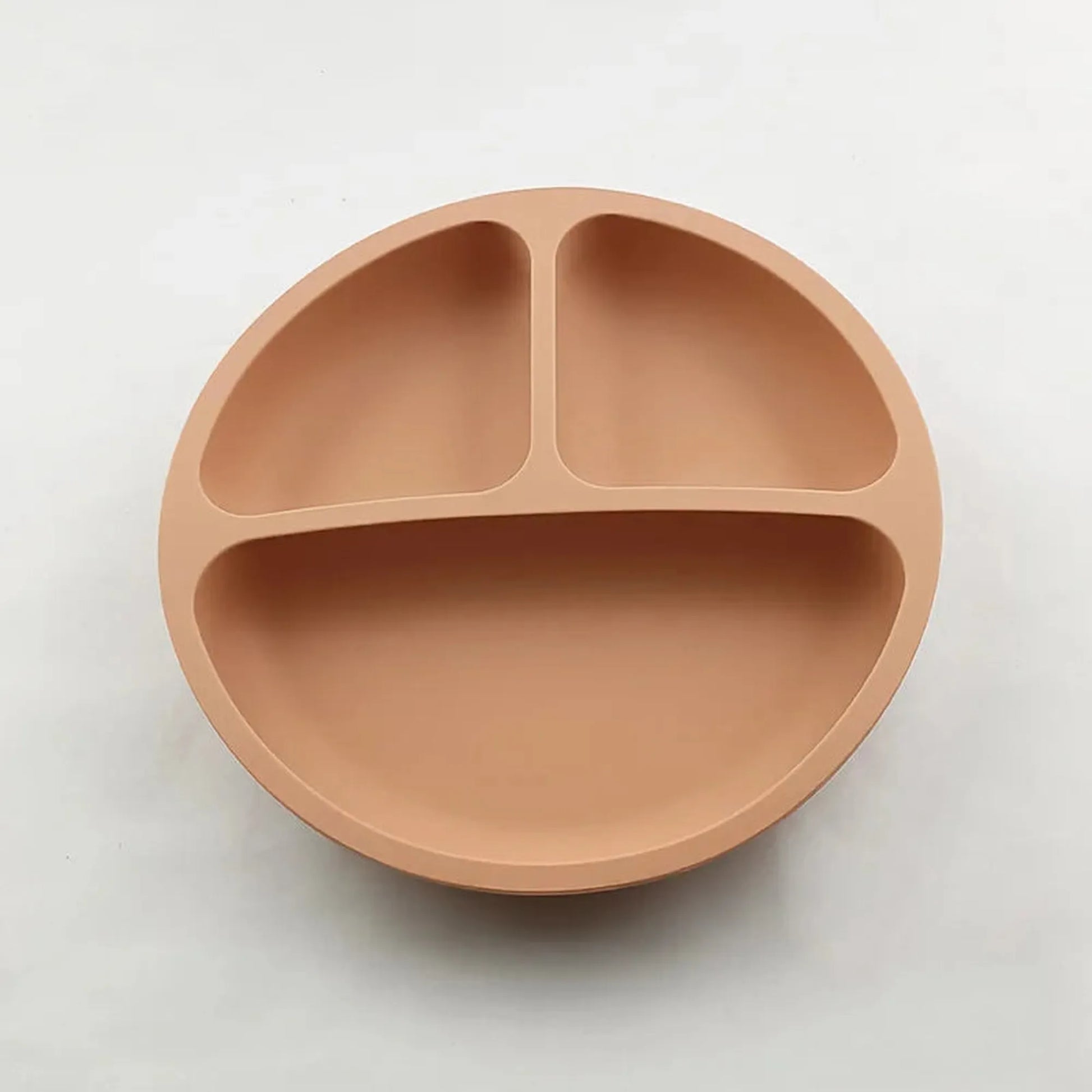 Peach silicone baby plate with strong vacuum base and three compartments.