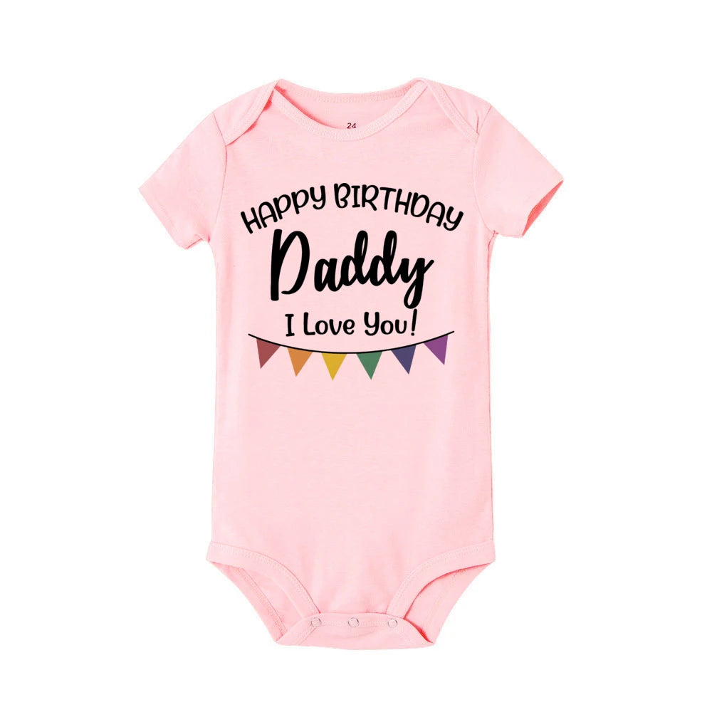 Pink short-sleeve baby bodysuit with "Happy Birthday Daddy I Love You!" text and colorful banner.