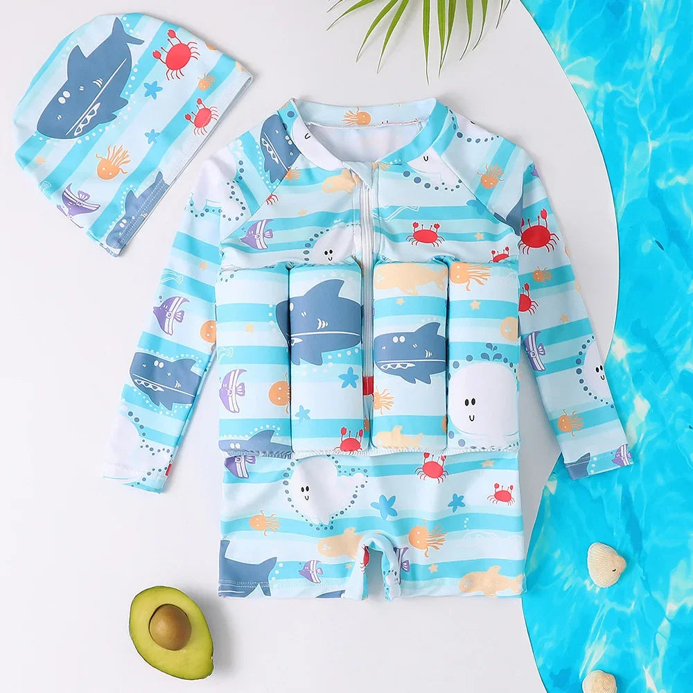 Kids' blue long-sleeve float swimsuit with cartoon sharks, crabs, and matching swim cap.