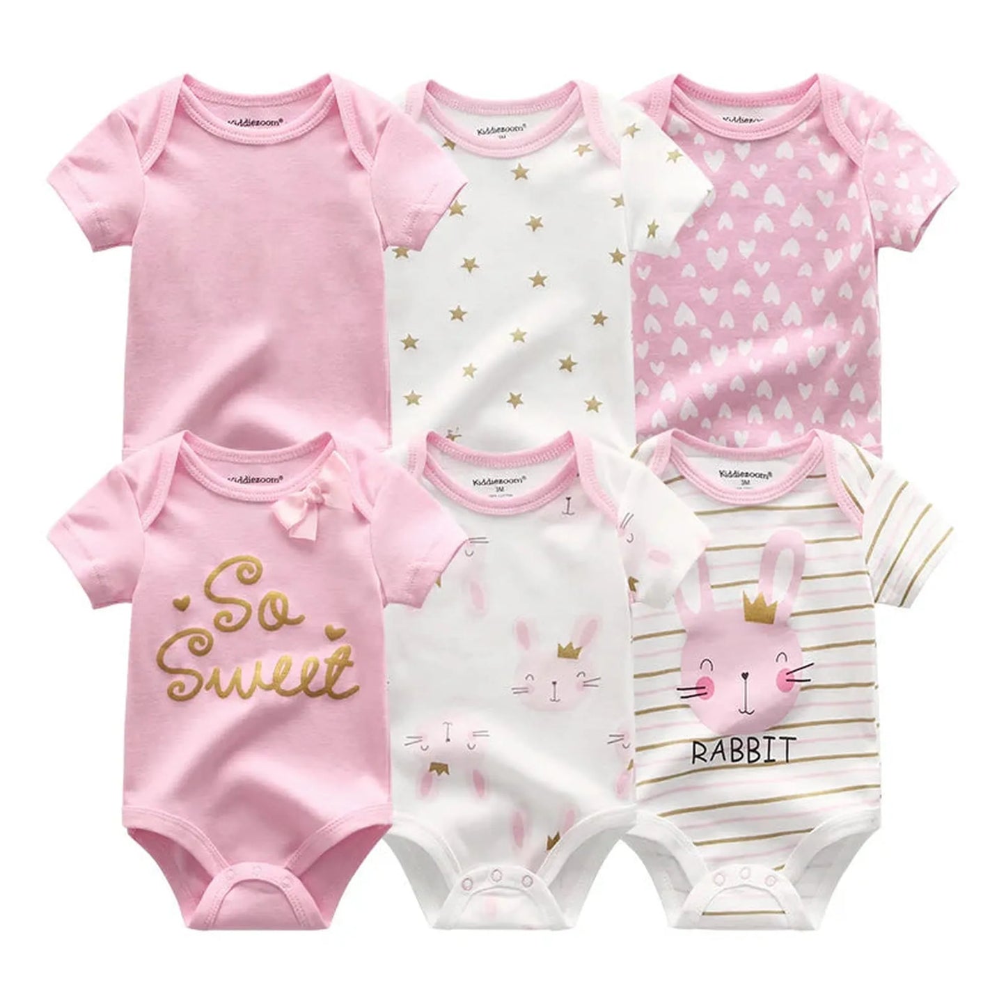 Six short-sleeve cotton baby rompers: pink solids, white with gold stars, pink hearts, "So Sweet" text, bunny faces, and striped with a 3D bunny.