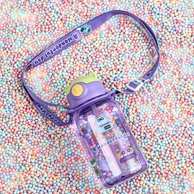 Purple 650ml kids' water bottle with straw, handle, and "A Wonderful Day" strap, on colorful beads.
