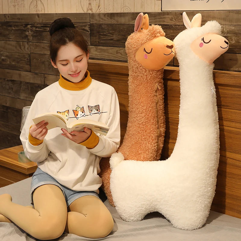Soft white and brown alpaca plush toys, 75cm-130cm, next to a woman reading.