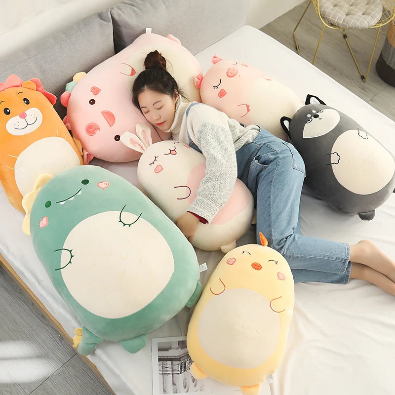 Soft plush animal pillow collection with a woman cuddling a white bunny, surrounded by colorful dinosaur, lion, pig, and wolf pillows.