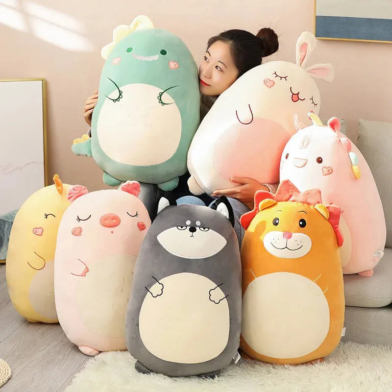 Woman holding soft plush animal pillows: green dinosaur, pink bunny, and unicorn, surrounded by a yellow lion, pig, husky, and yellow animal.