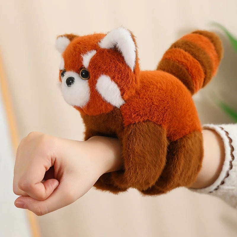 Soft, 20cm plush red panda toy worn on a child's wrist, featuring orange, brown, and white fur.