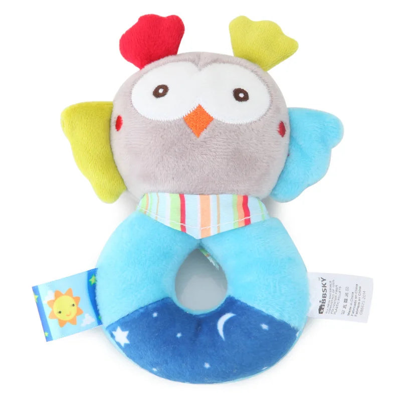 Soft plush owl baby rattle and teether with colorful wings and a blue ring.