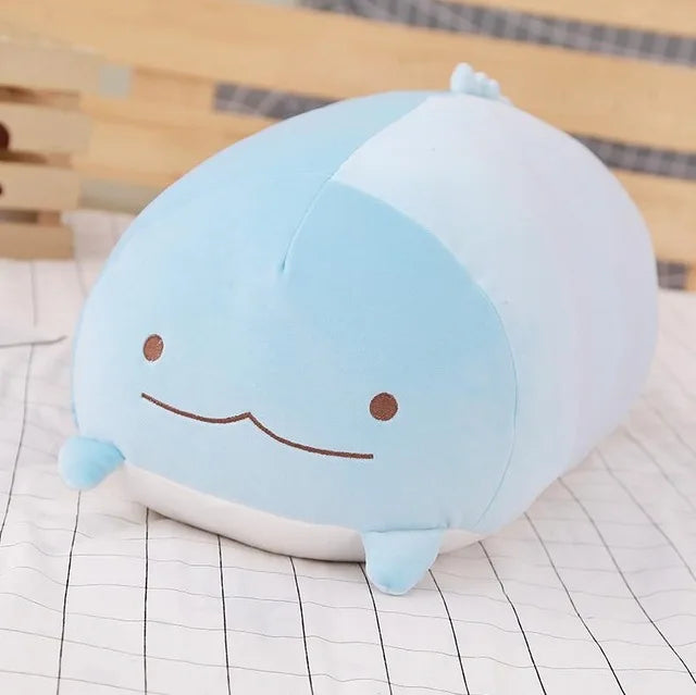 Soft blue plush whale animal pillow, 20cm, with embroidered eyes and mouth on a checkered surface.