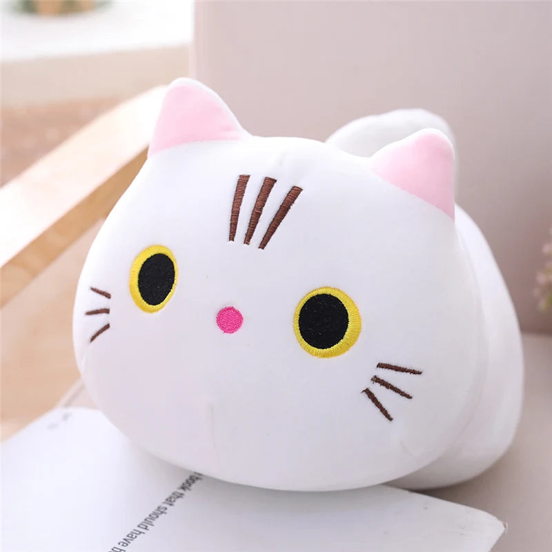 Soft white plush cat toy with pink ears, yellow eyes, and embroidered whiskers.