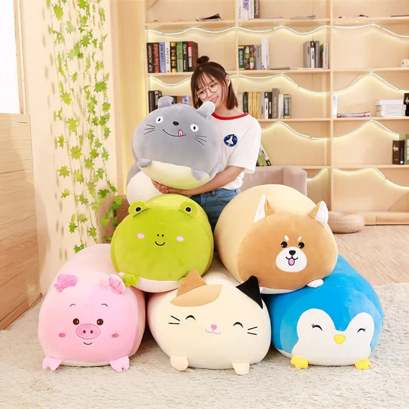 Soft plush animal pillows: gray Totoro, green frog, brown dog, pink pig, cream cat, blue penguin.