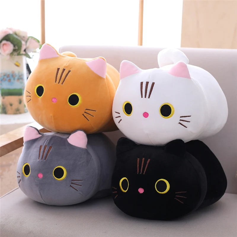 Four soft plush cat toys in orange, white, gray, and black, with pink ears and embroidered faces.