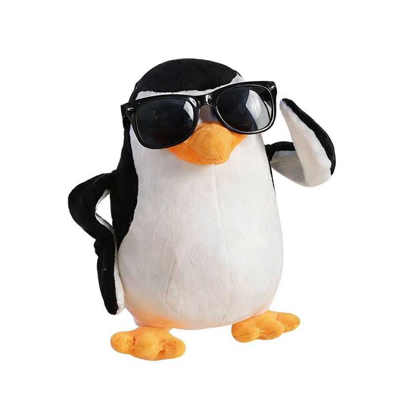 Soft plush black and white penguin toy with orange beak and feet, wearing black sunglasses.