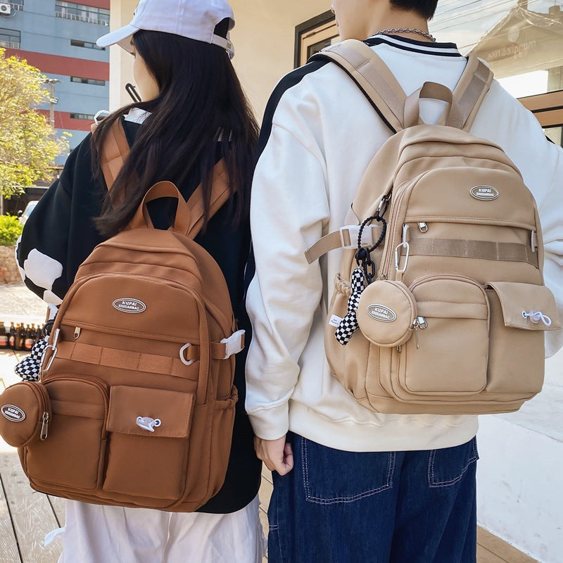 Two students wearing stylish, water-resistant nylon backpacks: one brown, one beige, with laptop compartments.