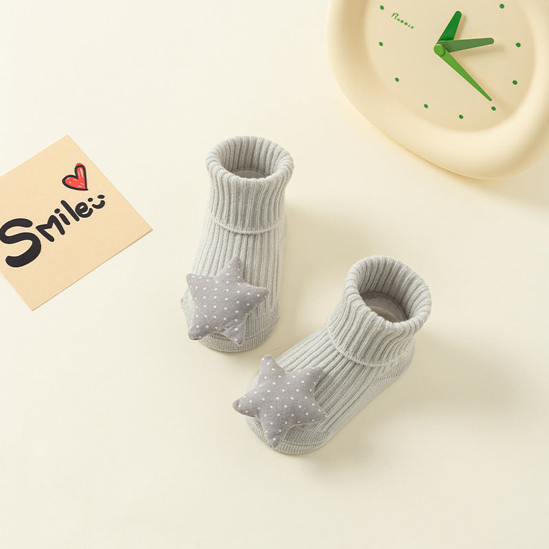 Gray ribbed cotton baby socks with dotted star anti-slip design.