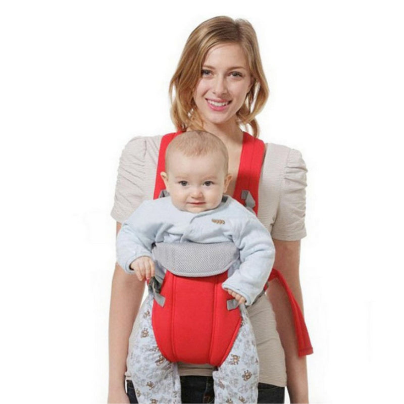 Smiling woman carrying baby in a red ergonomic multi-purpose carrier with a hip seat.