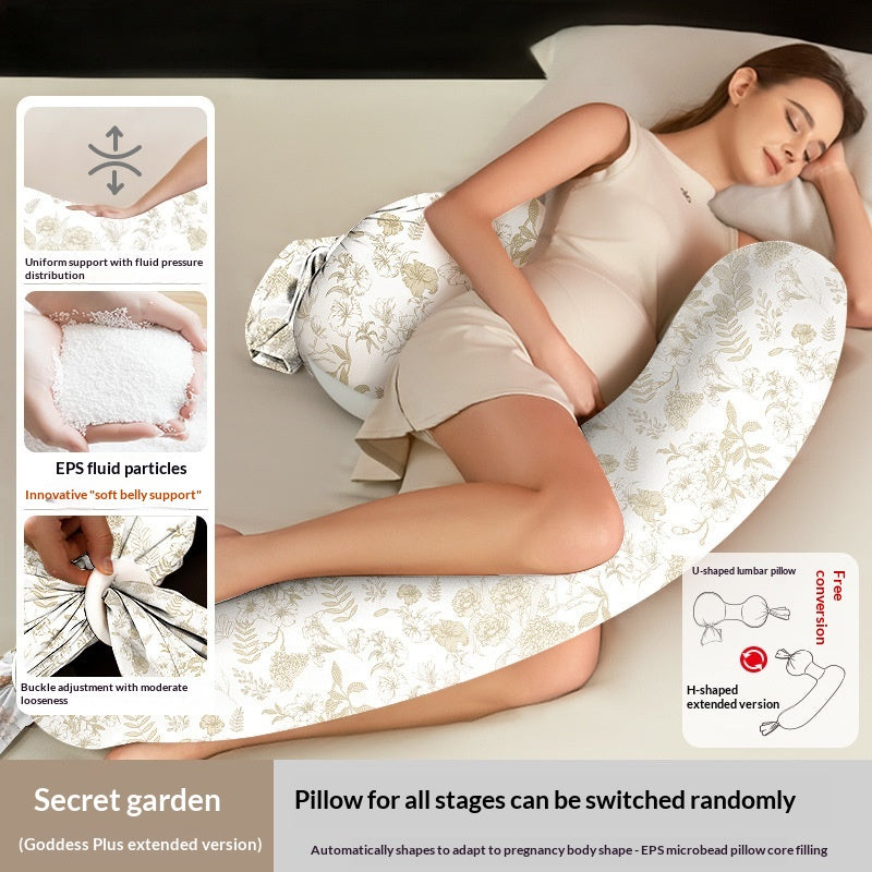 White U-shaped pregnancy pillow with gold floral pattern, supporting a sleeping pregnant woman.