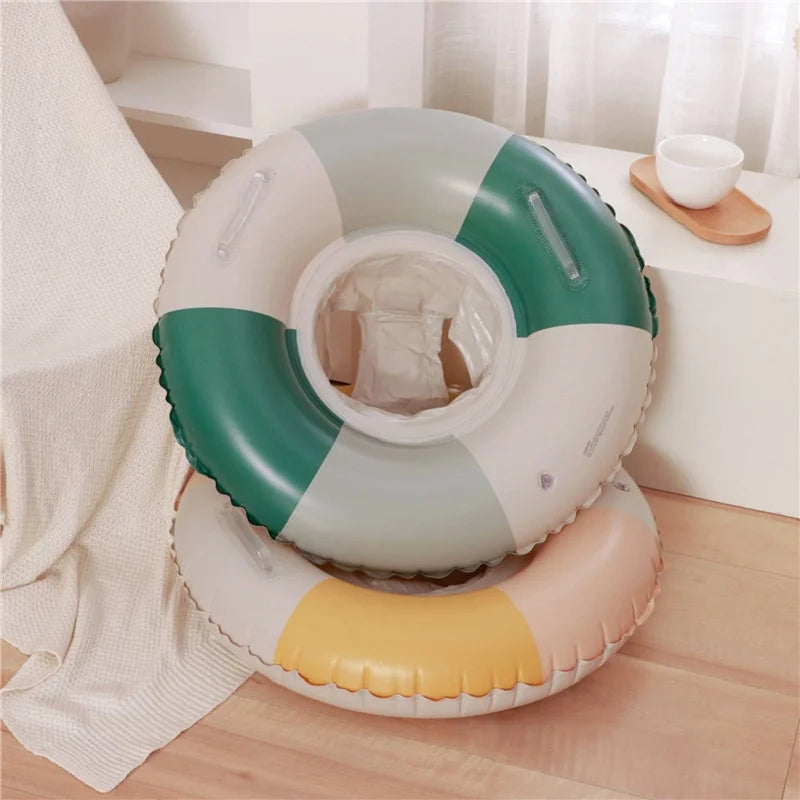 Inflatable baby swim float with sun canopy, featuring green, grey, and white color blocks.