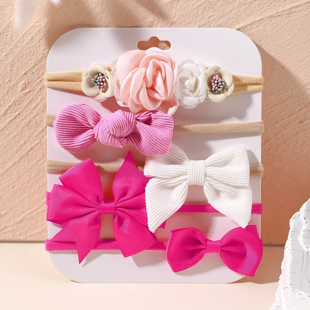 Set of 5 baby headbands: pink floral, lace, and bow designs on soft nylon and cotton.