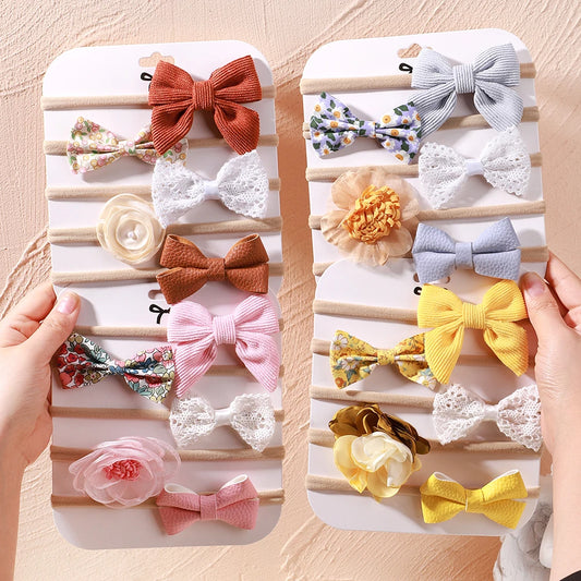 Two sets of 5 baby headbands with various lace flowers, bows, and fabric designs in pink, yellow, brown, and white.