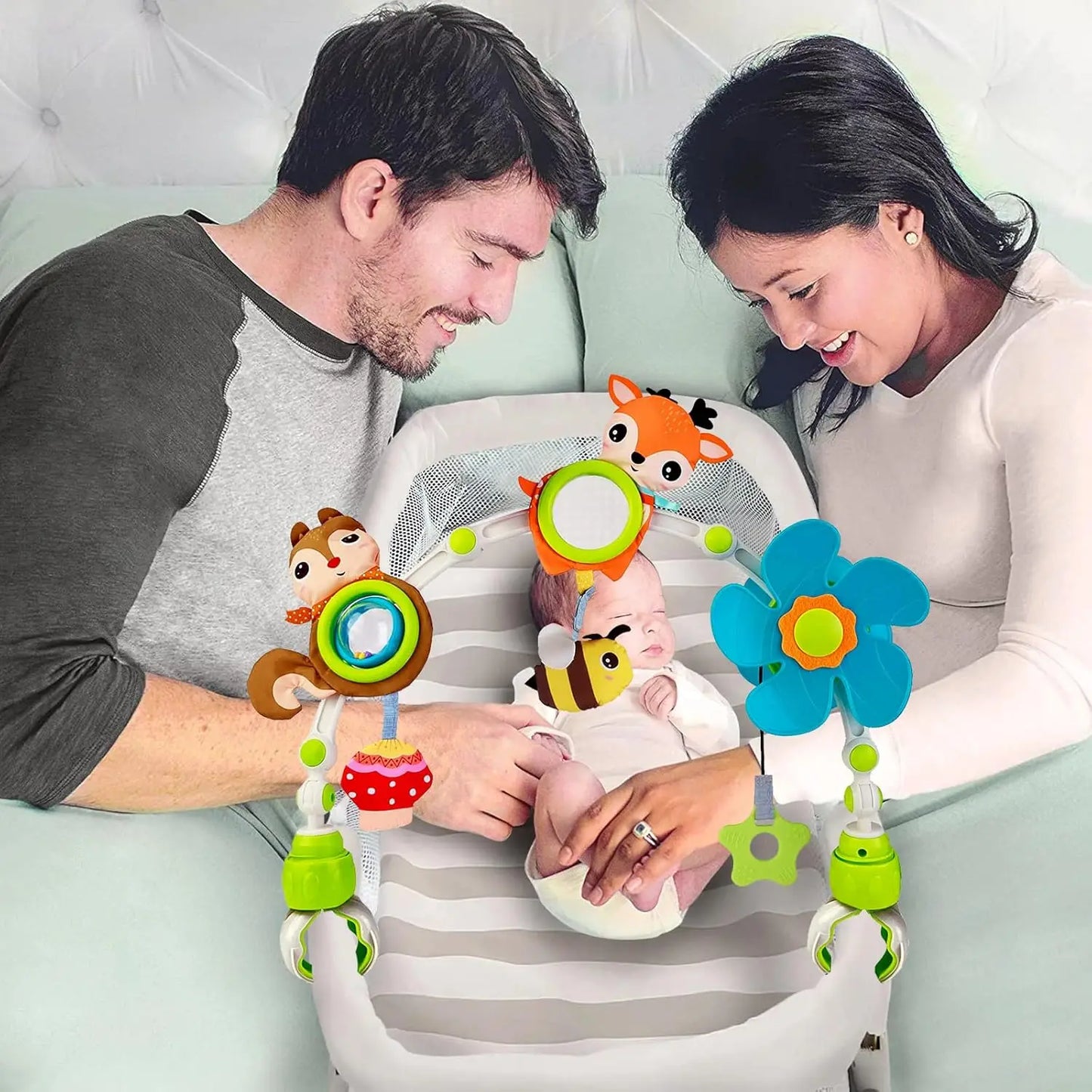 Activity arch for baby stroller with hanging toys, universal clips, and a baby playing.