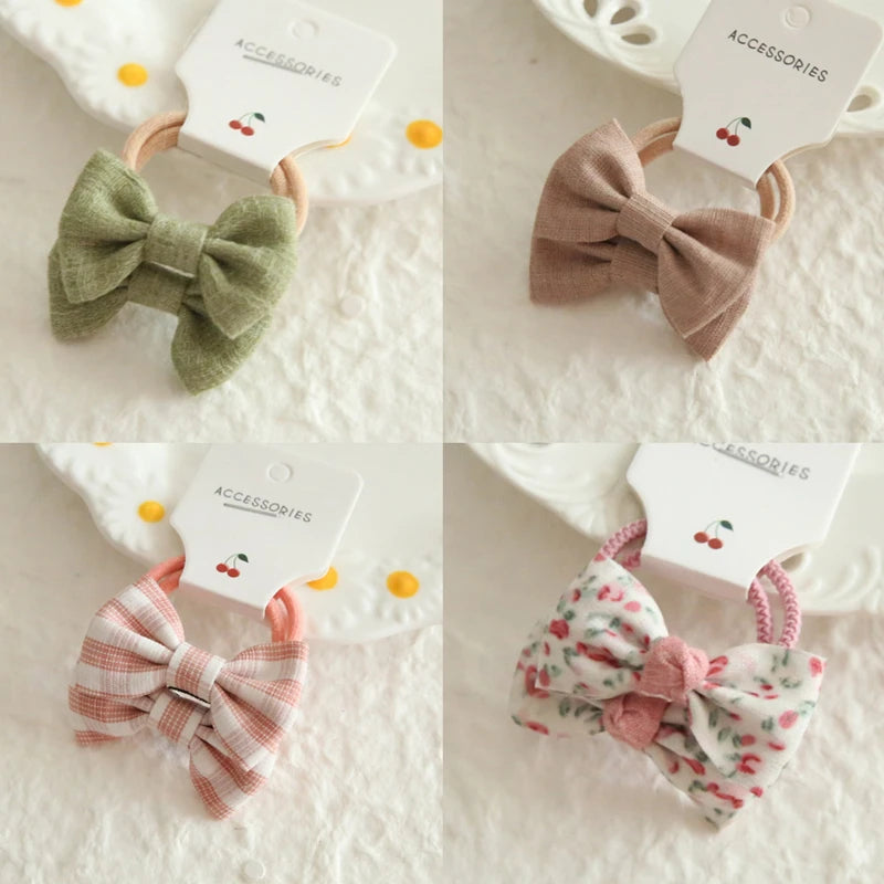 Four soft cotton hair bows for babies and girls: green, brown, pink plaid, and white with cherry print.