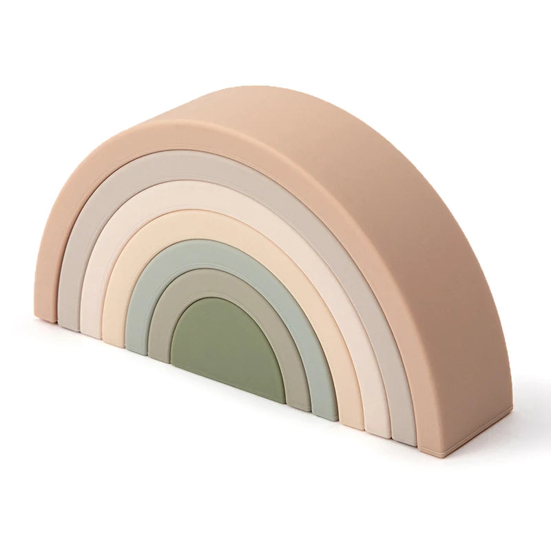 Soft silicone rainbow stacking toy in muted pastel colors for babies.