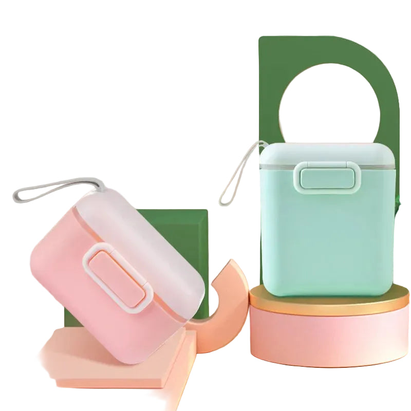 Pink and mint green portable formula dispensers with measuring spoon compartment.