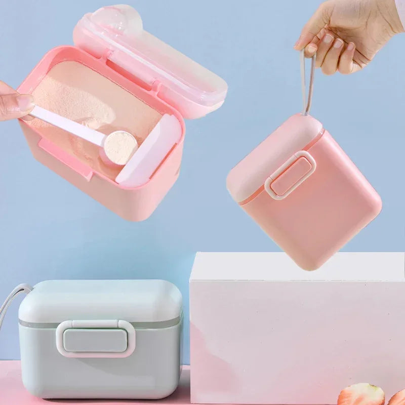 Pink and mint green portable baby formula dispenser with separate spoon compartment.