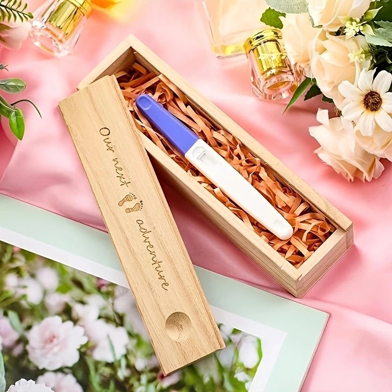 Wooden keepsake box for pregnancy test, engraved "Our next adventure" with footprints.