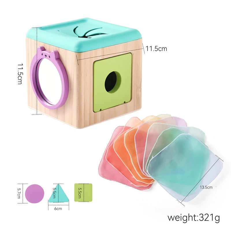Wooden sensory tissue box toy with colorful scarves, a mirror, and shape sorter.