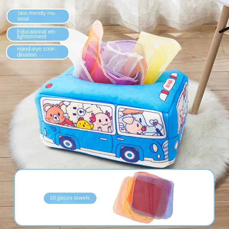 Blue plush Montessori tissue box toy shaped like a bus, filled with colorful gauze scarves.