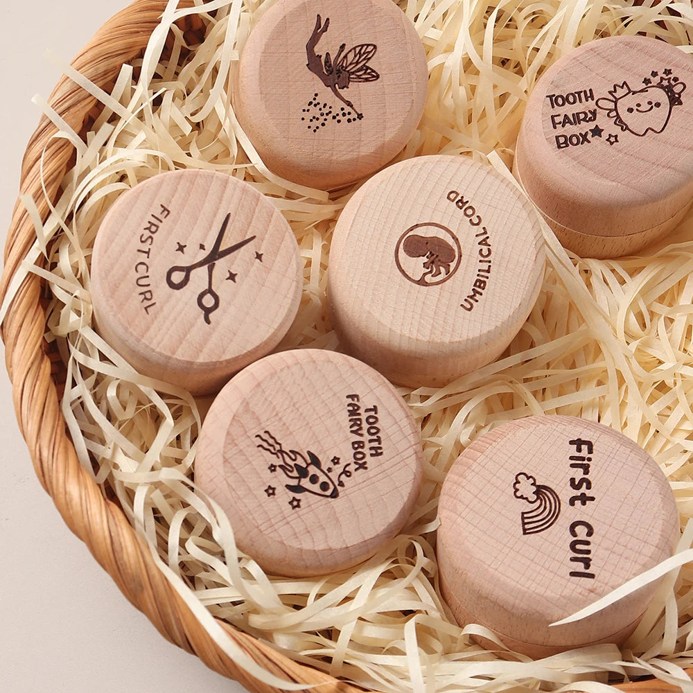 Six round natural beechwood baby keepsake boxes with engraved designs in a woven basket.