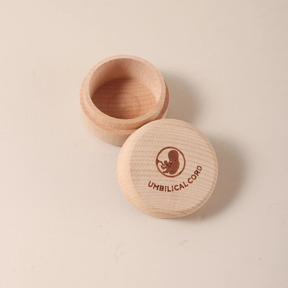 Round natural beech wood keepsake box with "UMBILICAL CORD" and fetus etched on the lid.