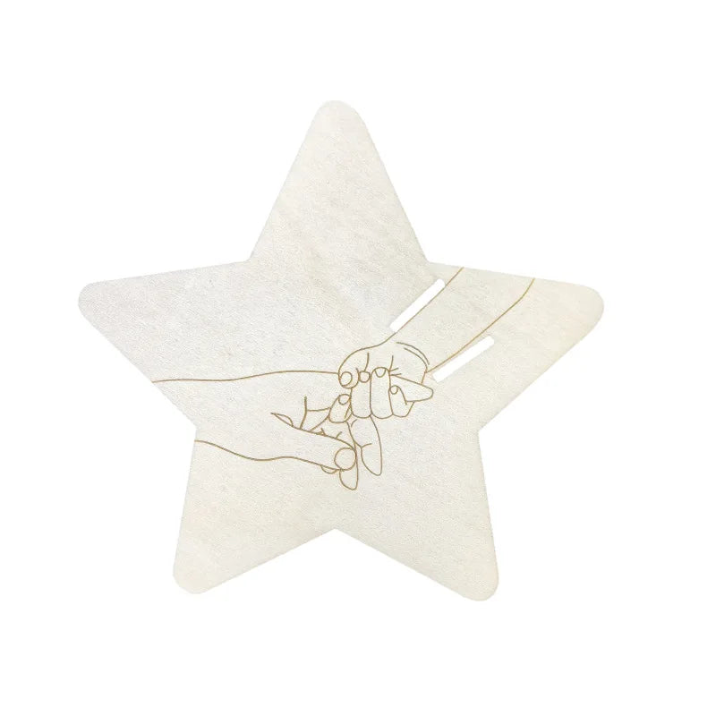 Star-shaped wooden birth keepsake with engraved parent and baby hands, designed to hold a hospital bracelet.
