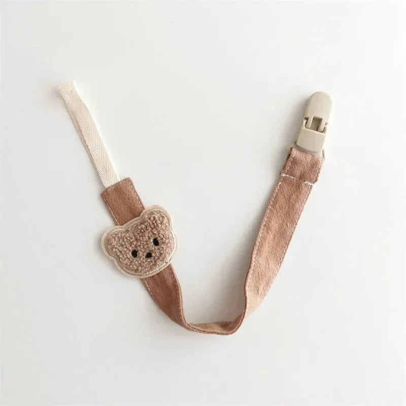 Embroidered brown teddy bear cotton pacifier clip with a beige plastic clasp.