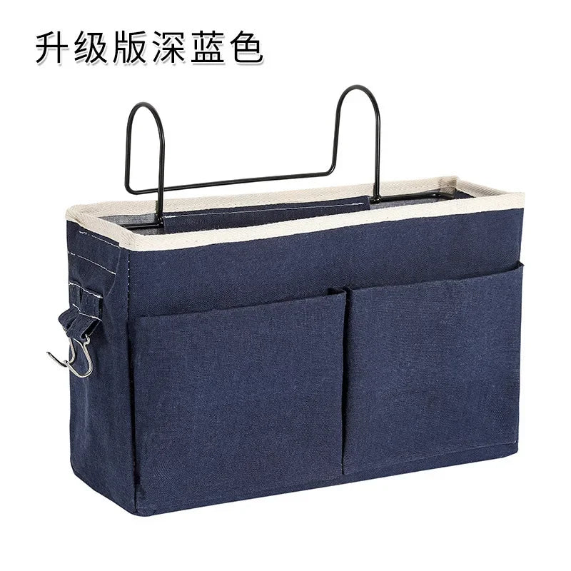 Dark blue multi-pocket cotton blend bedside caddy with metal hooks, perfect for baby storage.