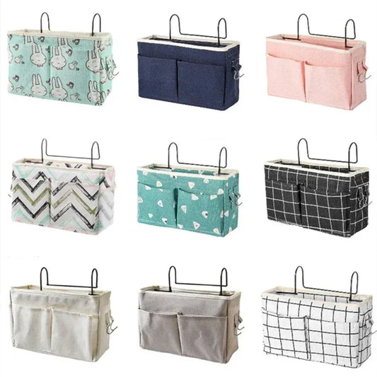 Assorted multi-pocket cotton bed organizers with metal hooks in various colors and patterns.