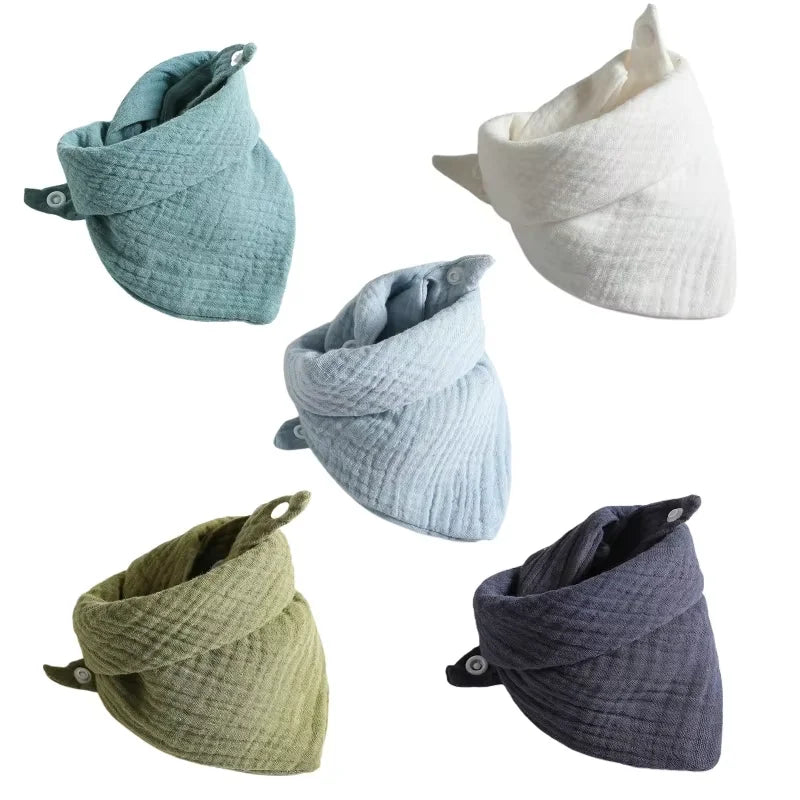 Set of 5 soft cotton baby bibs in various colors: teal, white, light blue, olive green, and dark gray, with snap buttons.