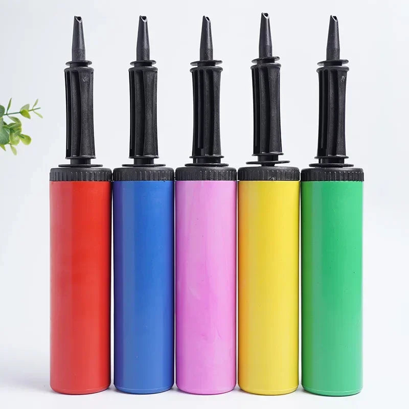 Five colorful manual balloon pumps: red, blue, pink, yellow, and green, with black ergonomic handles.