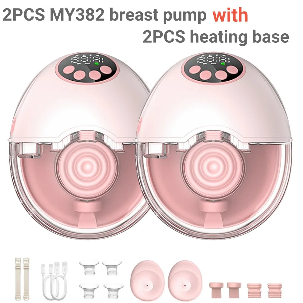 Two pink and white hands-free wearable breast pumps with digital displays, shown with heating bases and accessories.